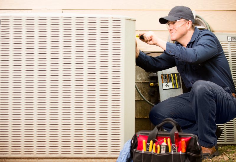 Female technician fixing AC for residential use in Knoxville, TN 