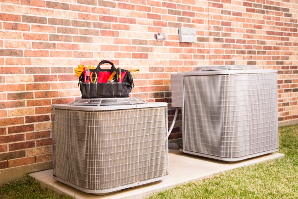 Outdoor AC units with tools for maintenance by Grissom Heat & Air in Knoxville, TN